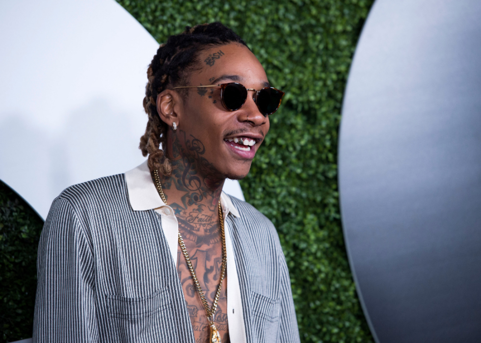 Wiz Khalifa poses for press at event.