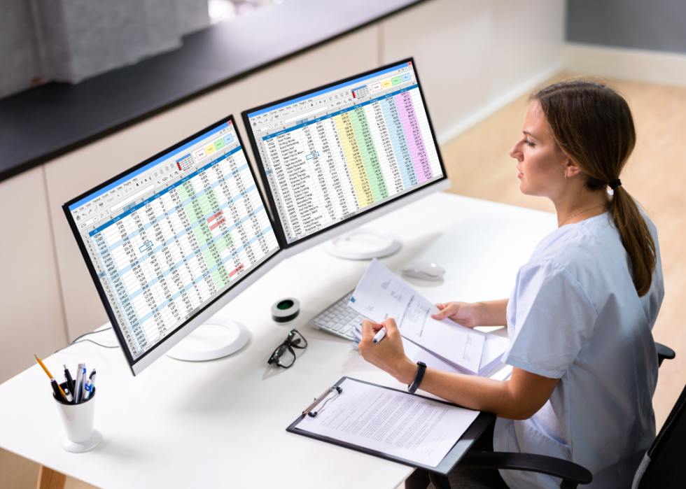 A medical professional doing billing on a computer.