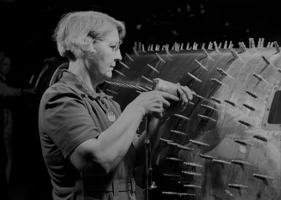 A woman drilling holes in a B-17F Flying Fortress at Boeing in Seattle.