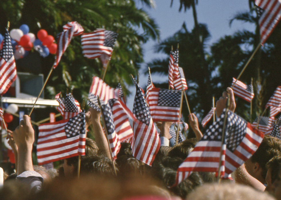 Supporters wave flags overhead on the presidential campaign trail.