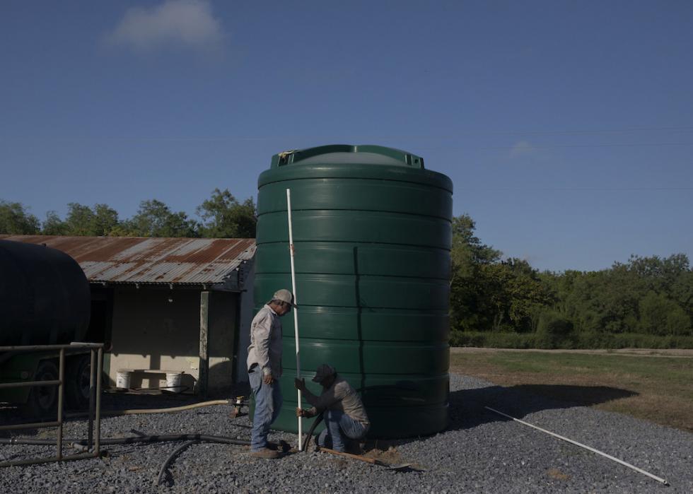 Workers trying to access water from the irrigation canal in Donna, Texas.