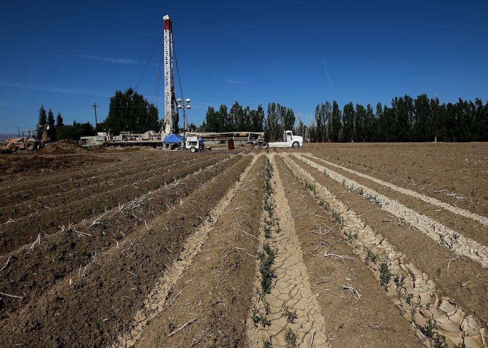 Workers drill a new well at a farm near Mendota, California.