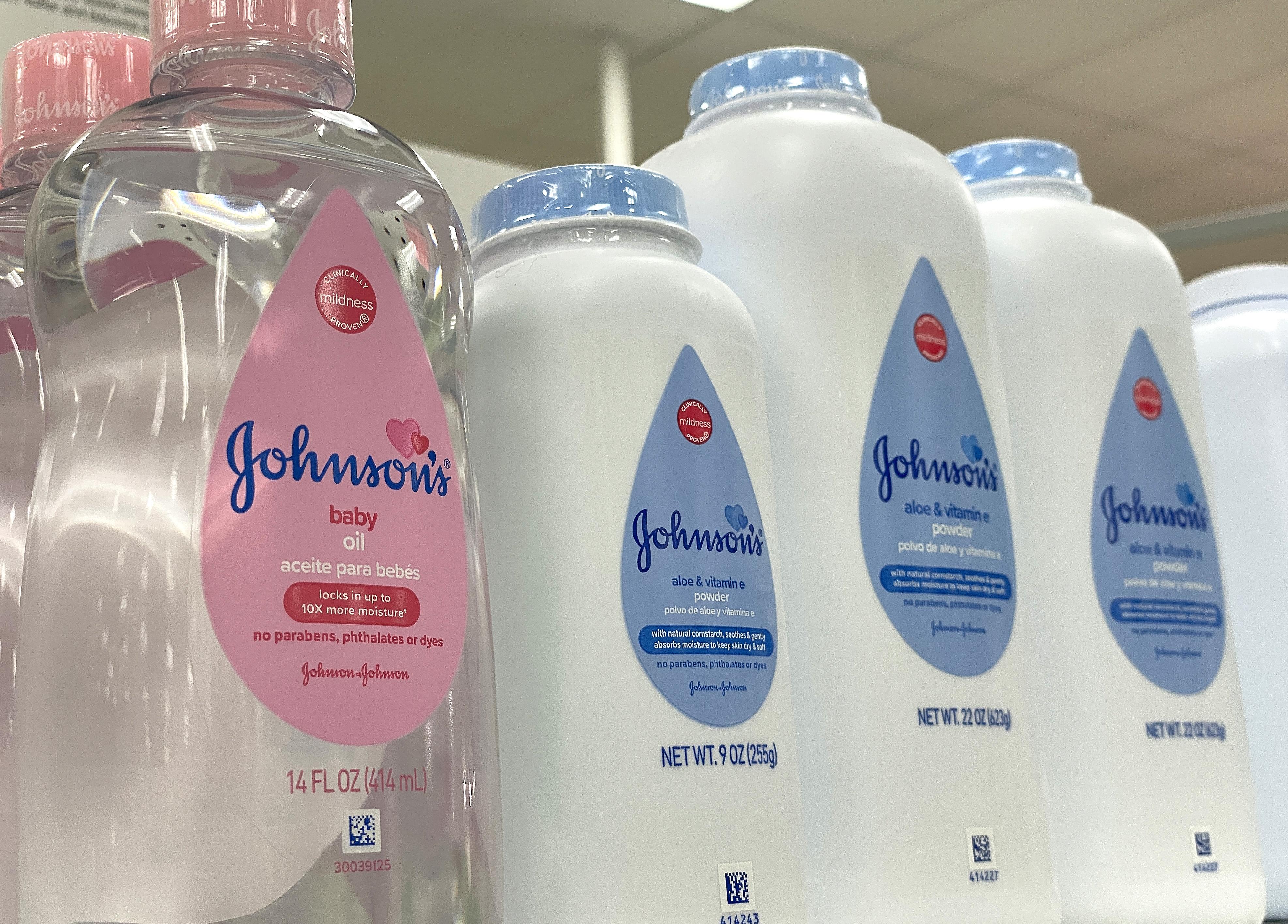 Johnson & Johnson's baby powder and baby oil on a shelf.