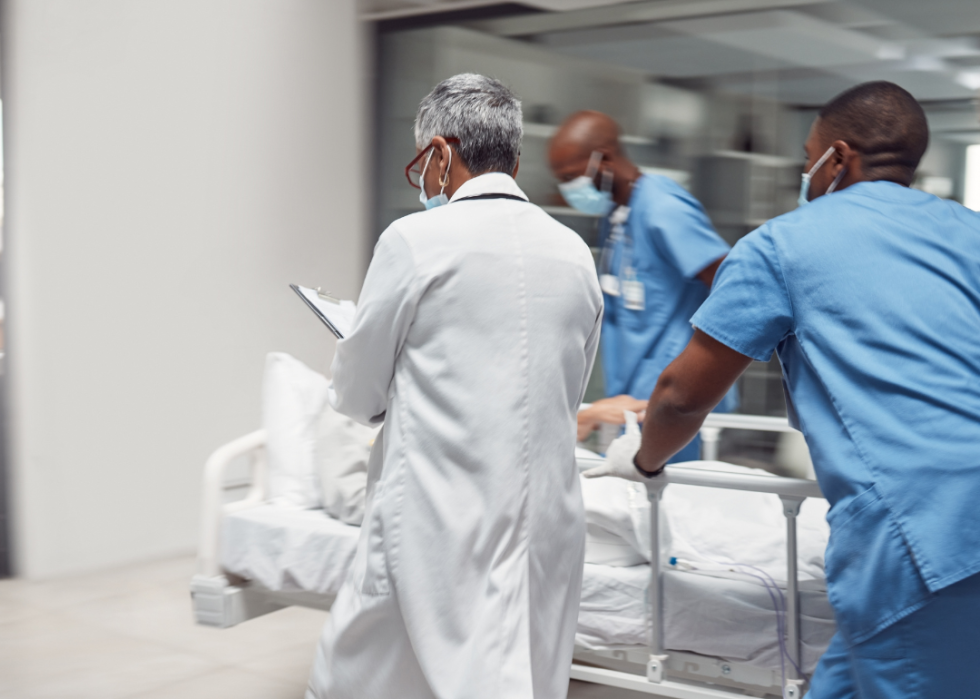 Emergency medical team pushing a stretcher.