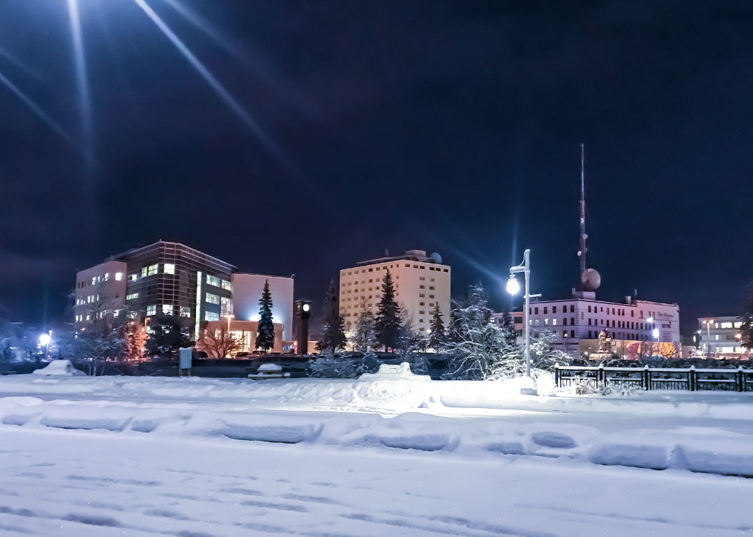 Snow-covered streets in Fairbanks with buildings in the background. 