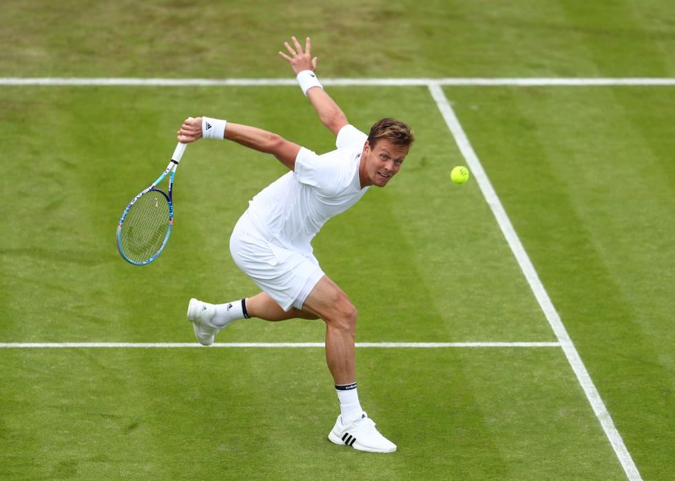 Tomas Berdych of The Czech Republic playing a backhand during the Men's Singles first round match against Ivan Dodig of Croatia on day two of the 2016 Wimbledon Lawn Tennis Championships 