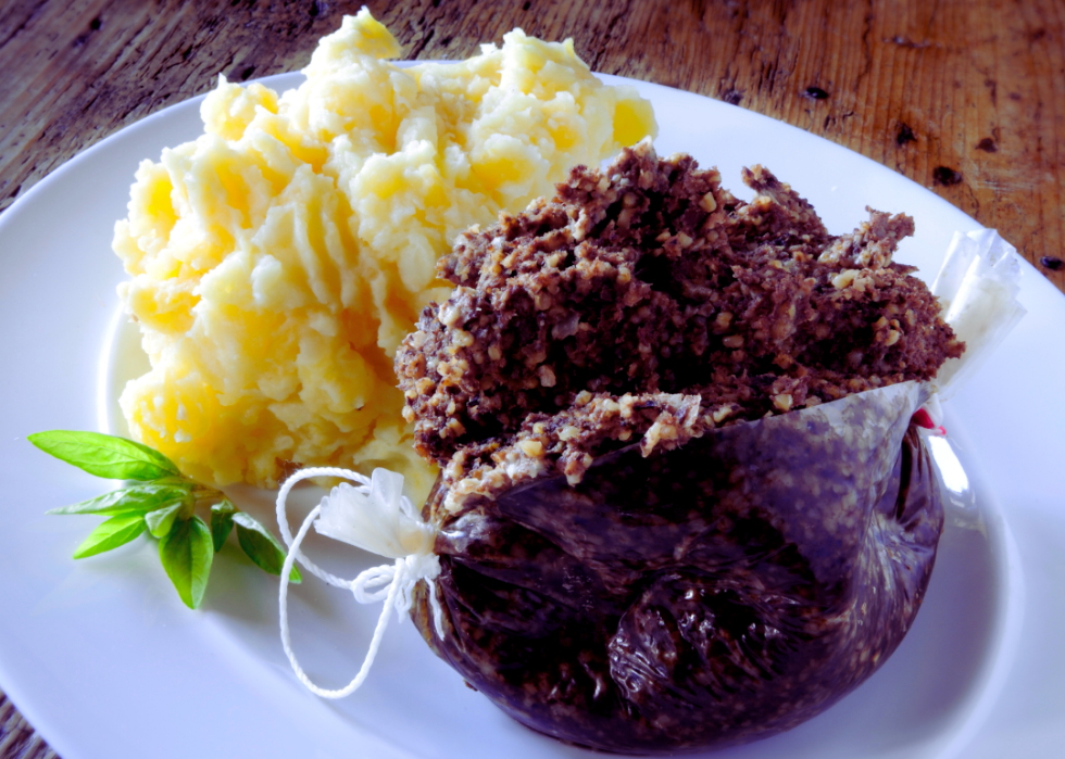 Plated haggis with mashed potatoes on the side.