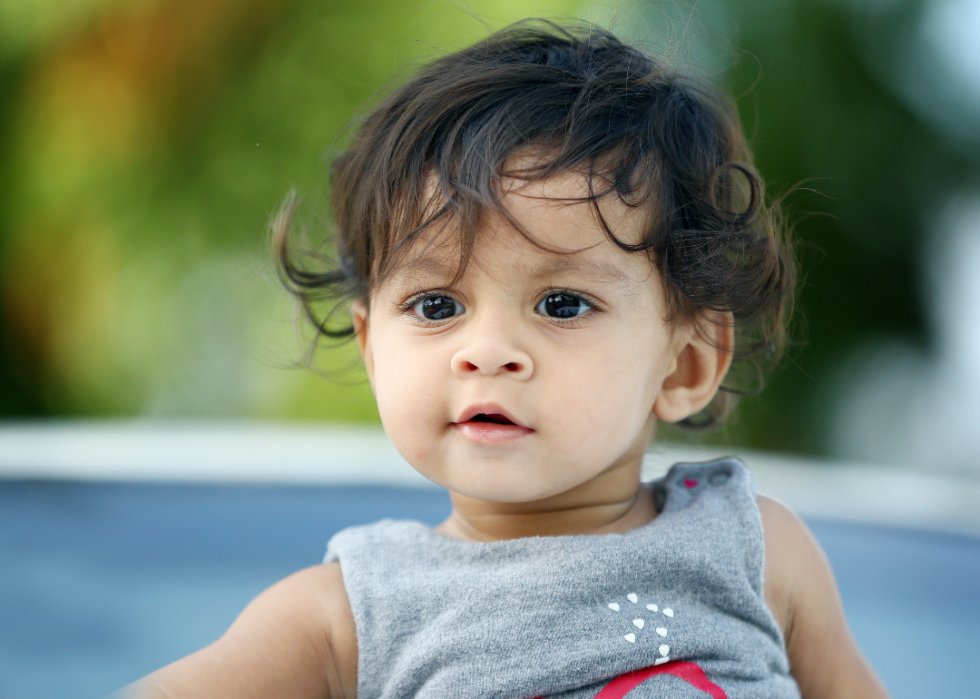 Indian Asian baby boy with curly hair. 
