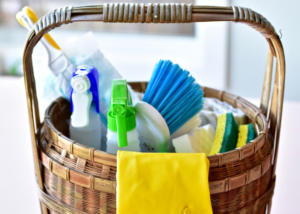 A basket of cleaning supplies in a sunny room