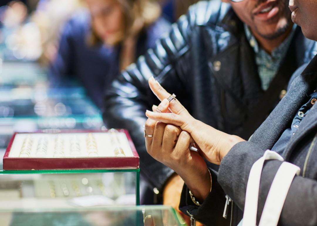 A couple trying on a ring.