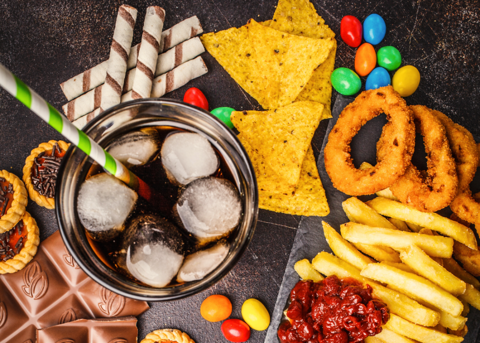 A selection of junk foods including soda, chips, candy and fried foods.