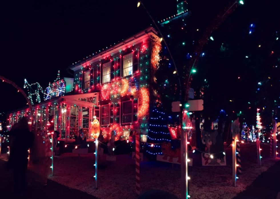 Candy Cane poles along the sidewalk with decorated homes.