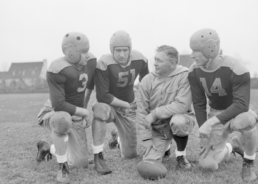 Curly Lambeau with players on the field.