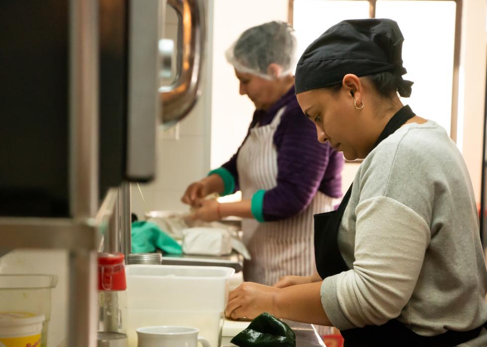 Food preparing workers in kitchen.