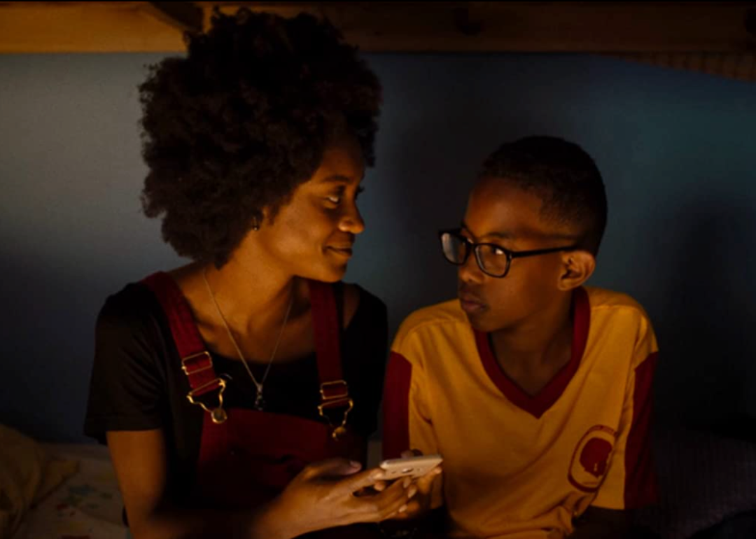 Camilla Damiao and Cicero Lucas sitting together in a dark room in a scene in Mars One.