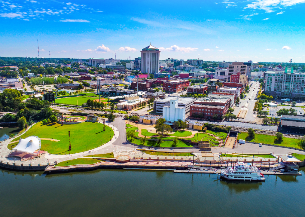 Aerial view of Montgomery on a sunny day with a river in the foreground.