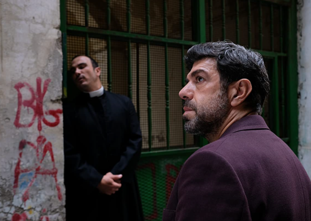 Pierfrancesco Favino and a priest in a scene from Nostalgia.