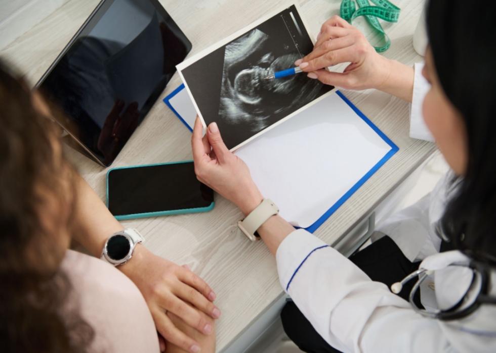 An Obstetrician showing a sonogram to a patient.