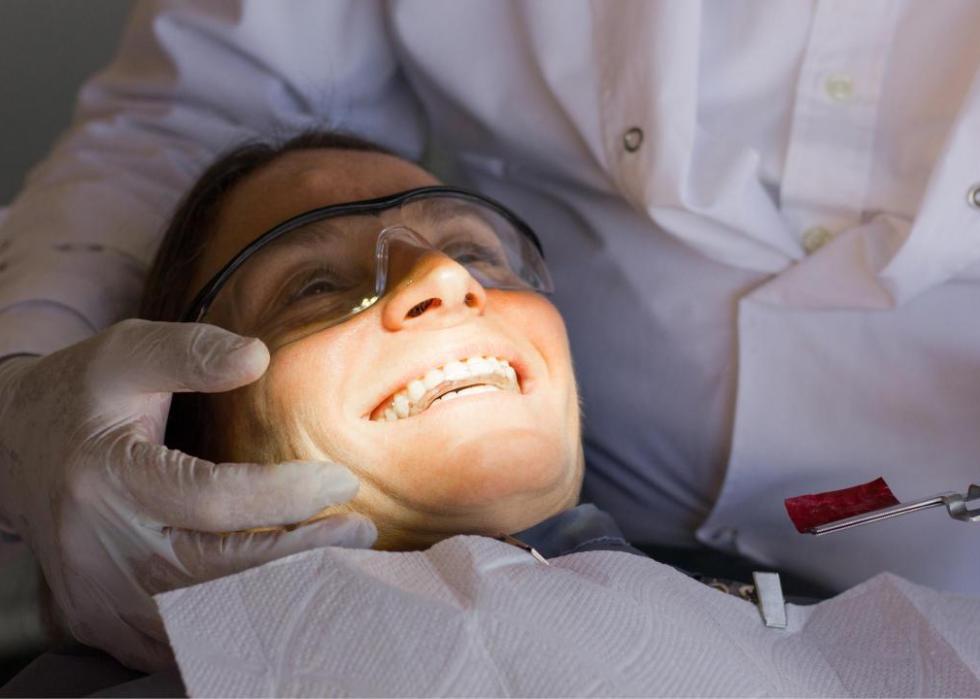 An orthodontist working on a woman's teeth.