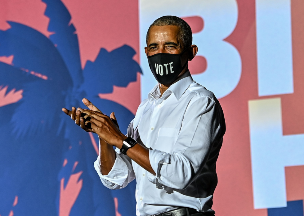 Obama, wearing a black face mask with the word Vote, speaks at a drive-in rally as he campaigns for Joe Biden in Miami in November 2020. 