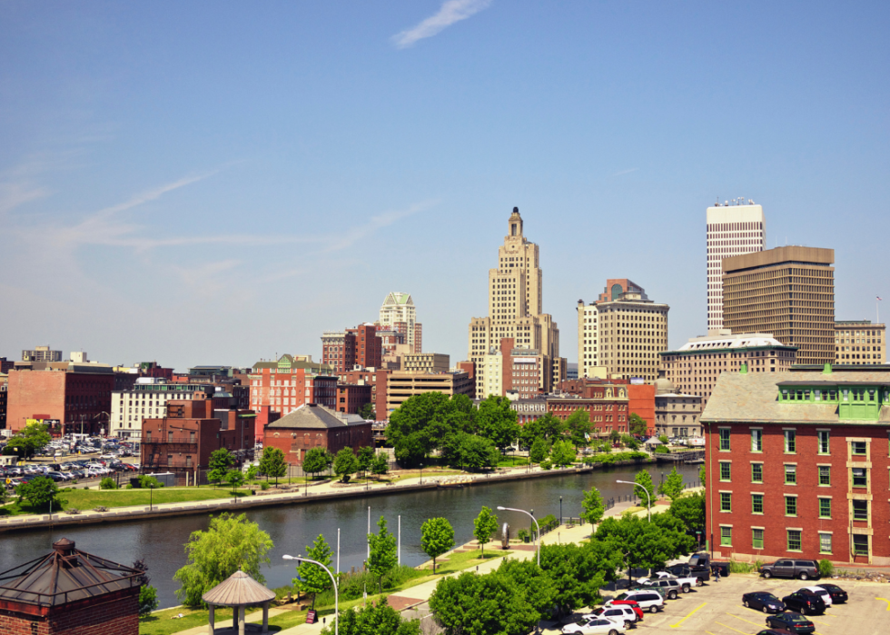 A city skyline with river in the foreground. 