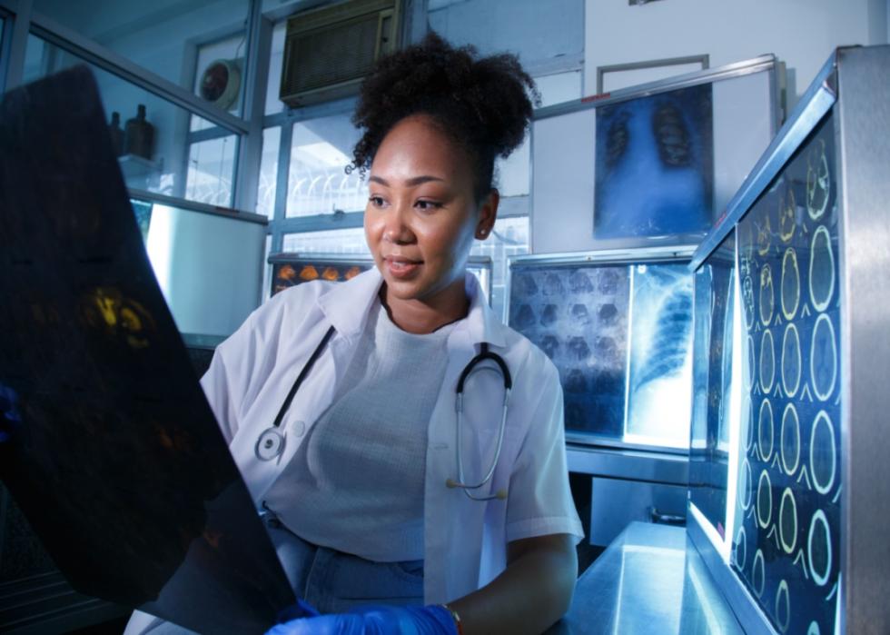 A radiologist looking at X-rays.