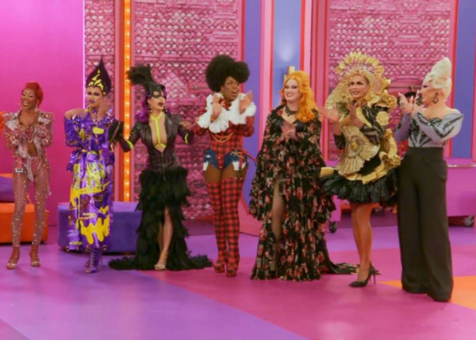 A lineup of contestant on a pink set