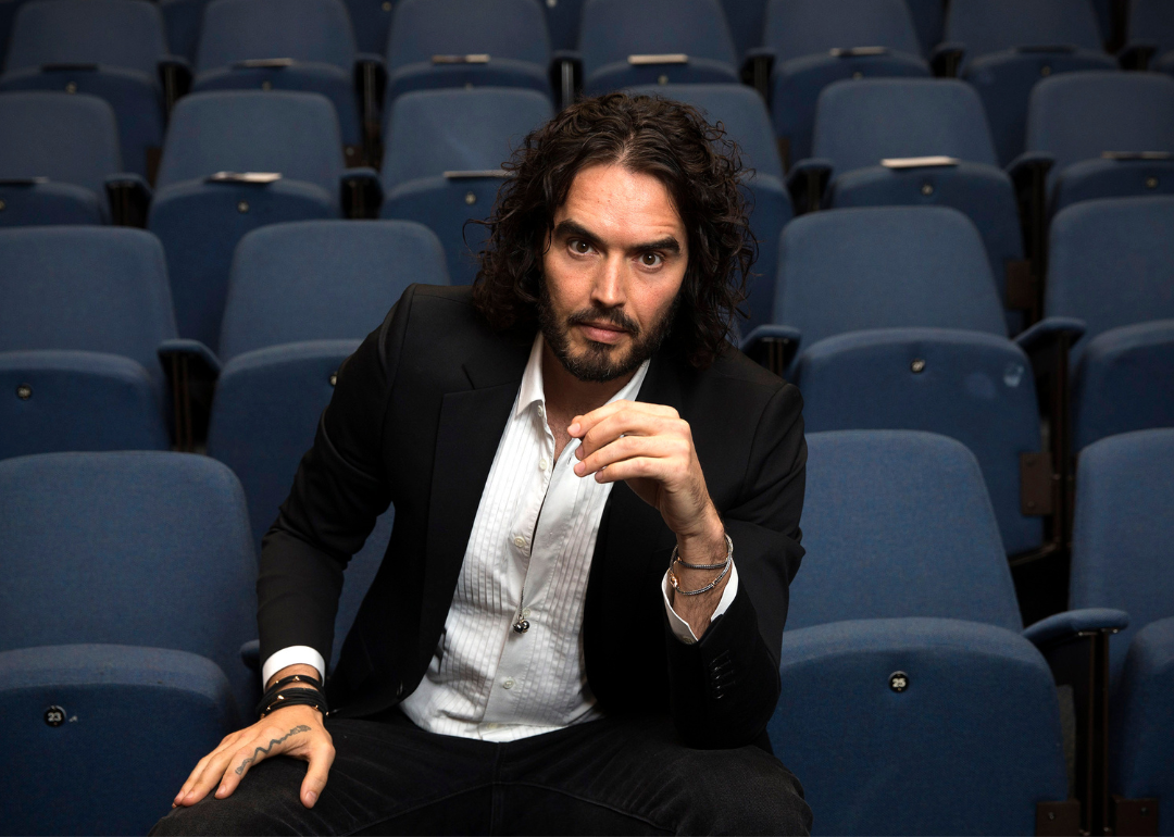 Russell Brand poses for photographers at an event.