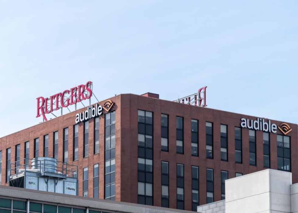 A large brick modern building with a sign that says Rutgers in red and audible in white. 