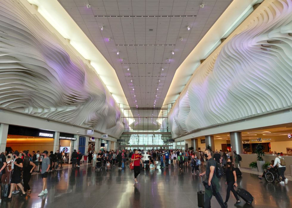 Passengers passing through the central area of a new terminal in Salt Lake City International Airport
