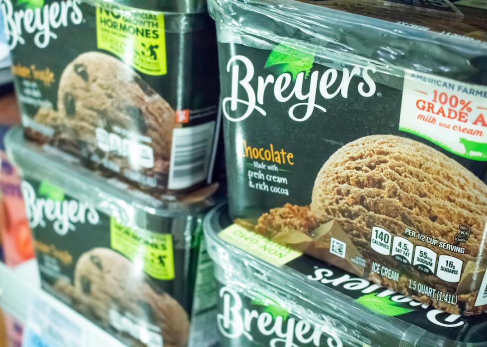 A view of several containers of Breyer's ice cream products in the freezer section of the grocery store.