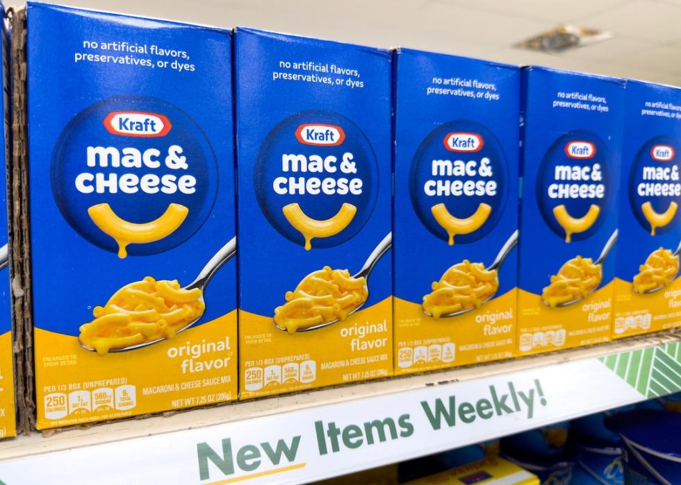 Boxes of Kraft macaroni and cheese on a shelf.