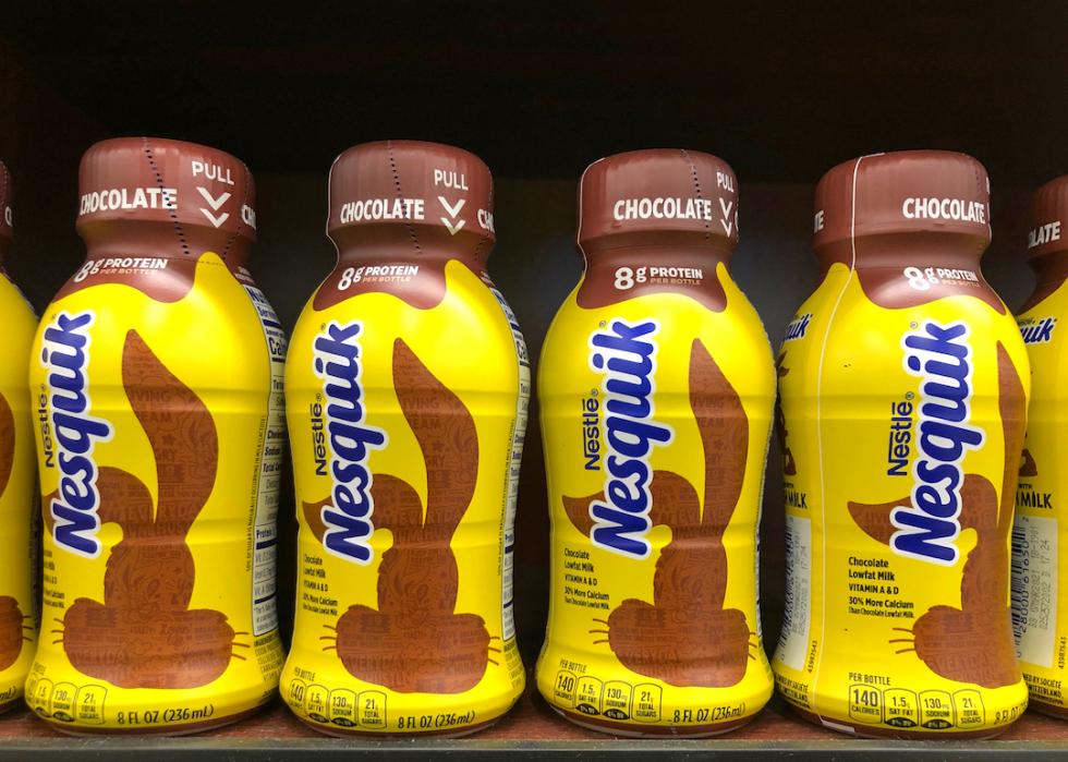 Grocery store shelf with bottles of Nesquik chocolate milk.