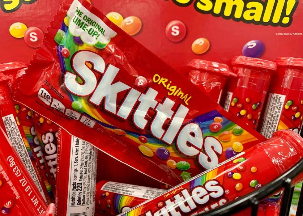 A close-up of original Skittles in red packaging.