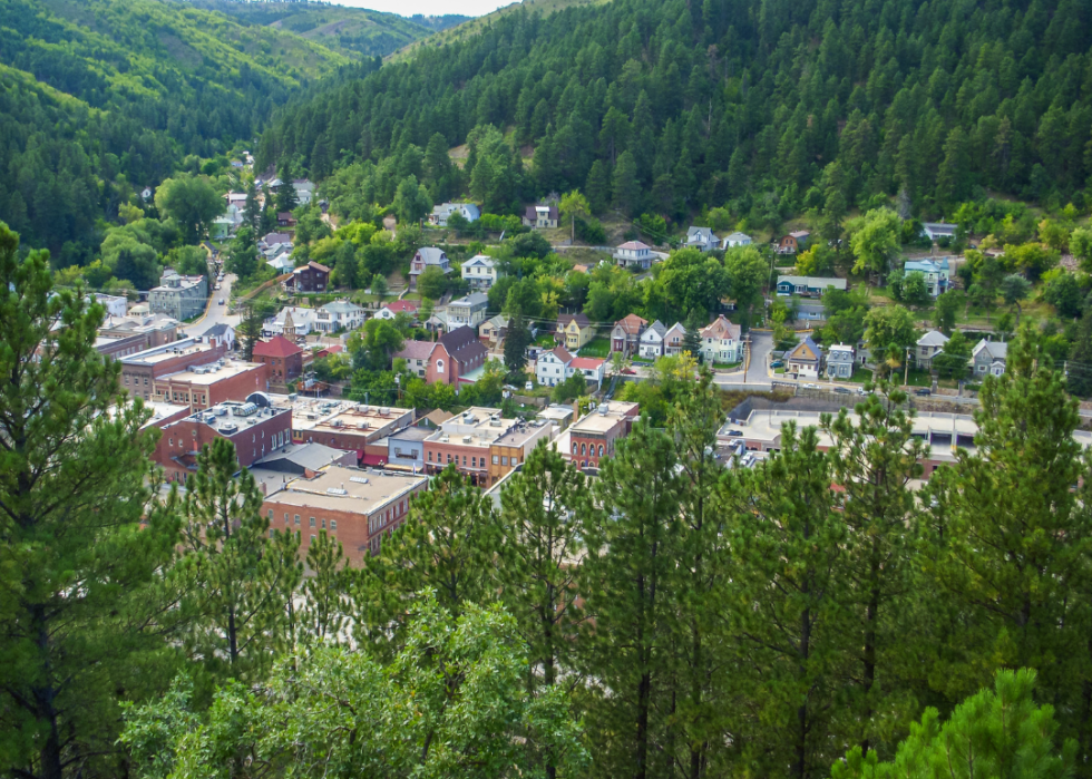 A town in the valley surrounded by lush green mountains.