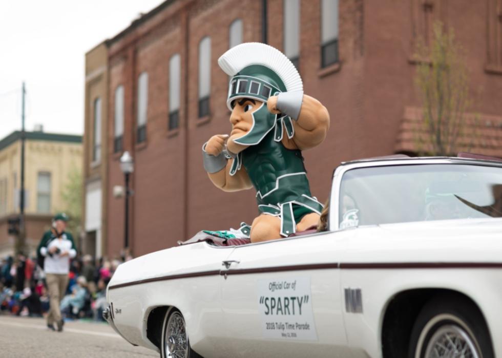 The Michigan State University mascot riding in a parade.