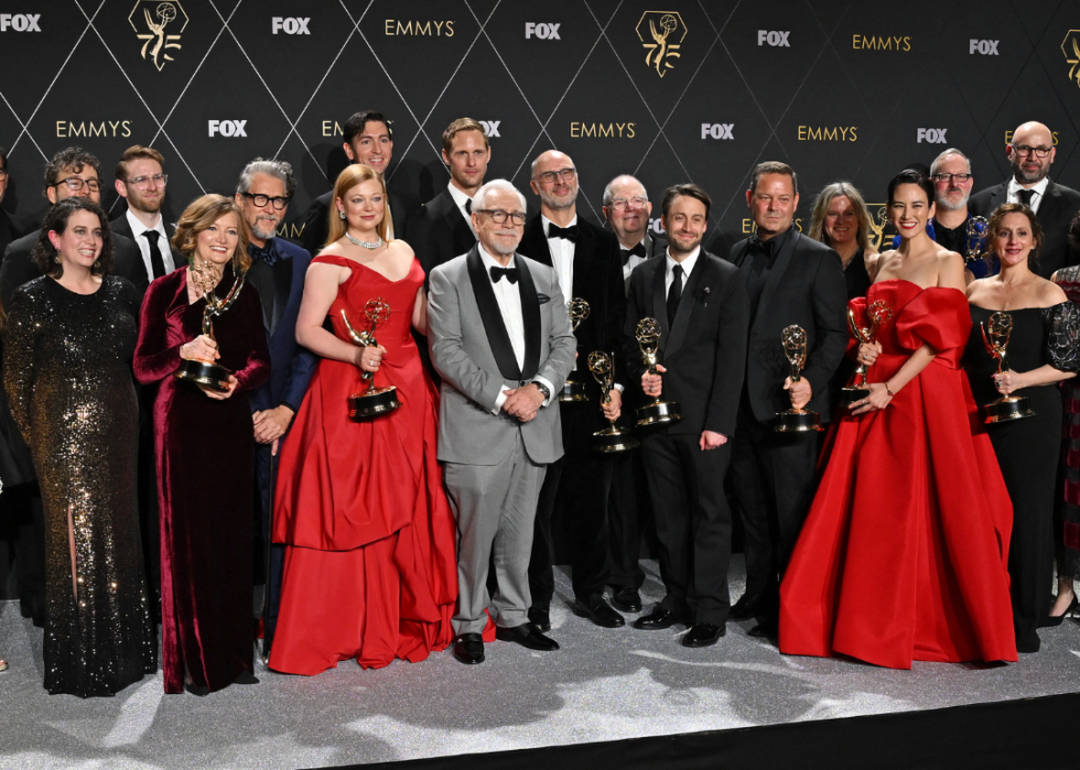 Cast and crew from "Succession" pose in the press room during the 75th Emmy Awards.