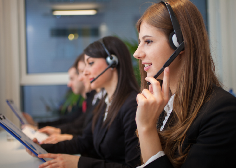 A young woman wearing a headset looking forward.