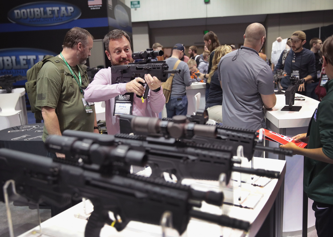 Guests shopping for firearms and accessories at a NRA Annual Meetings & Exhibits in Indianapolis.