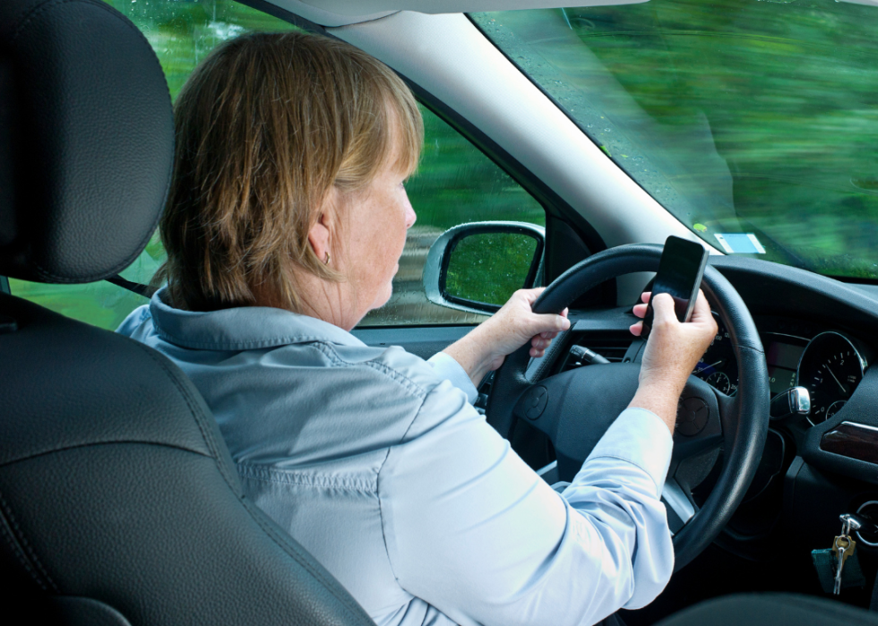 A woman texting while driving