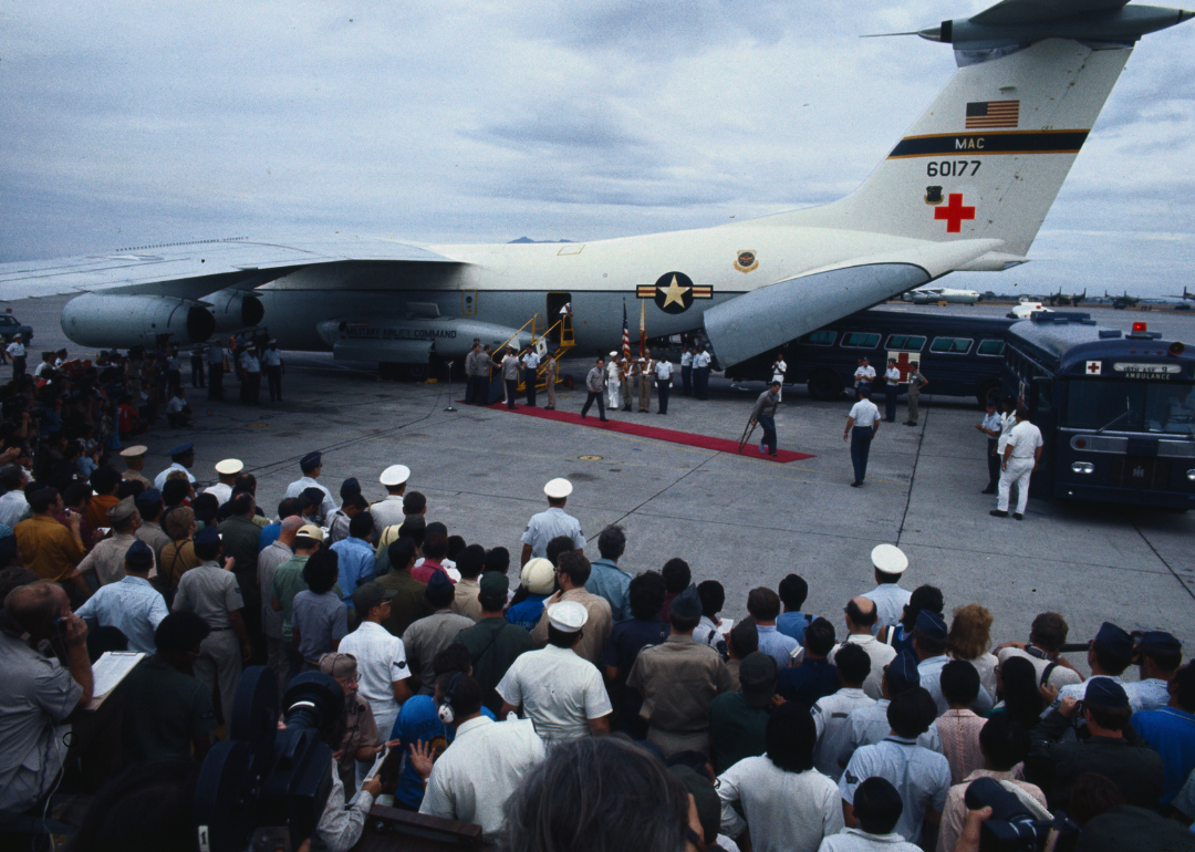 The first of the returning American POWs walking from their C-141 jet to a waiting bus on their arrival at Clark Air Force Base from Hanoi.