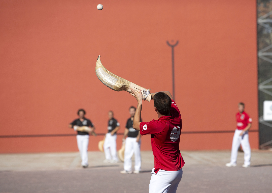 A group playing jai alai outside