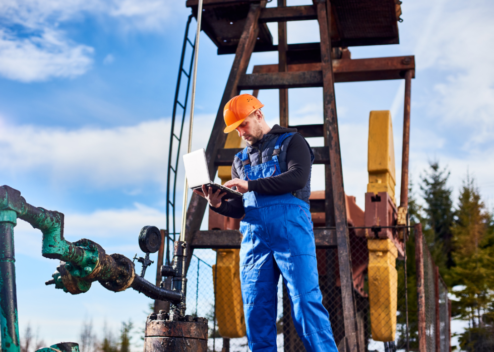 A man working near an oil rig.