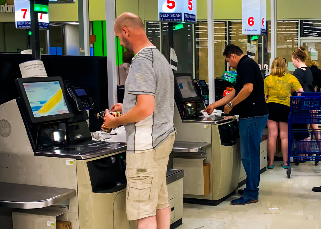Customers paying with credit cards at a self-checkout station at a grocery store in Detroit, Michigan.