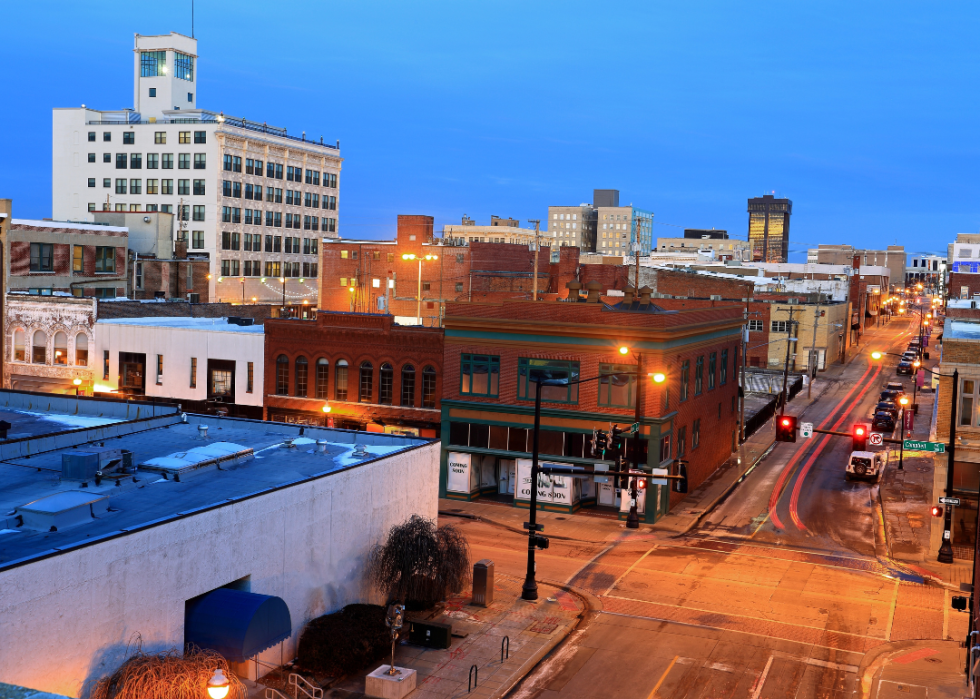 A street scene of cars and buildings at night in downtown Springfield, Missouri