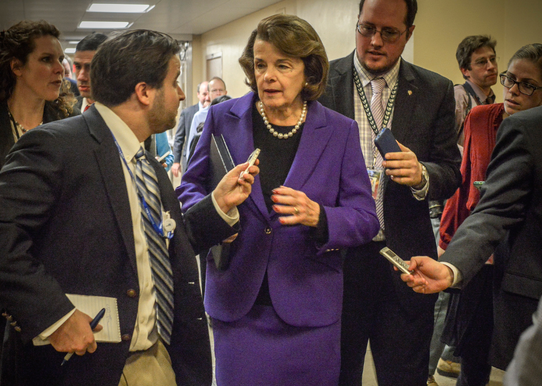 Sen. Diane Feinstein making her way through a crush of reporters toward the Senate floor to deliver her remarks on the CIA report on torture released the morning of December 9, 2014.