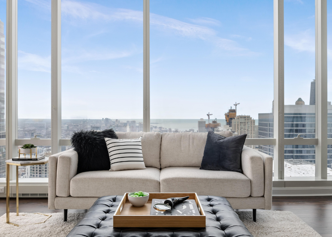 A stylish penthouse living room with skyline views of city and lakefront in Chicago.