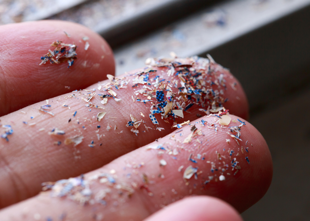Microplastics on a person's fingers.