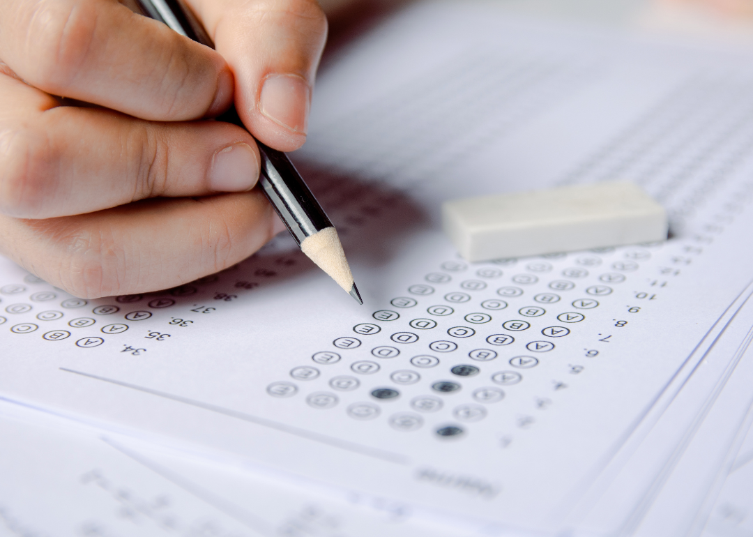 A student filling out a scantron form for a multiple choice test.