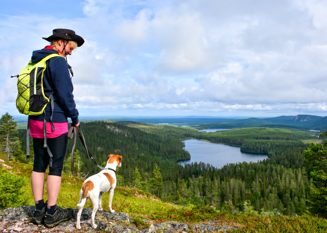 A person hiking with their dog.